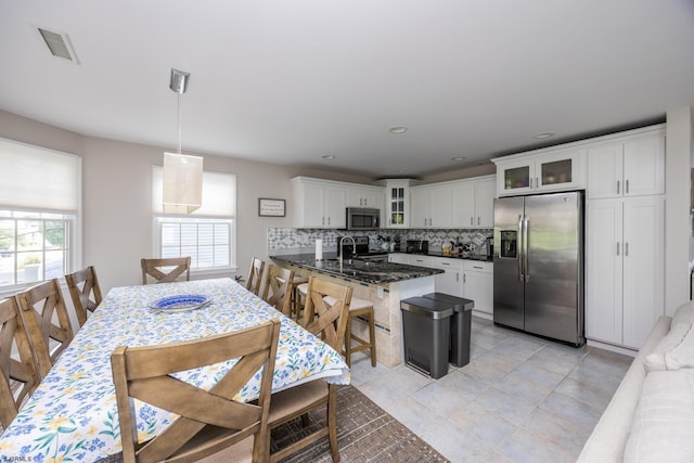 1611 Central Ave Unit 2, Ocean City, NJ 08226 - kitchen with appliances with stainless steel finishes, decorative backsplash, a peninsula, glass insert cabinets, and white cabinets