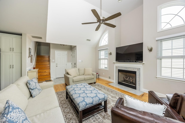 1611 Central Ave Unit 2, Ocean City, NJ 08226 - living area with high vaulted ceiling, ceiling fan, a tile fireplace, light wood-type flooring, and stairway