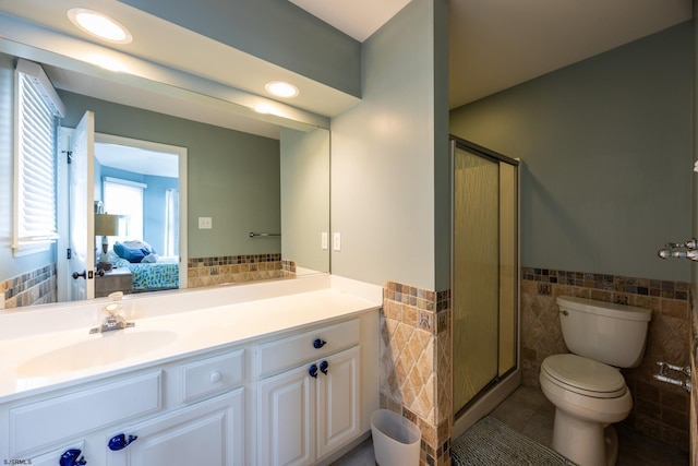1611 Central Ave Unit 2, Ocean City, NJ 08226 - ensuite bathroom featuring tile walls, vanity, a stall shower, wainscoting, and tile patterned floors