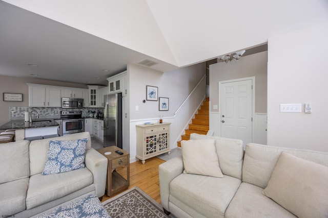 1611 Central Ave Unit 2, Ocean City, NJ 08226 - living area with light wood-type flooring, stairway, and vaulted ceiling