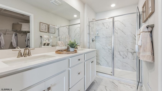 17 N 10th St, Middle Township, NJ 08251 - full bath featuring marble finish floors, double vanity, a marble finish shower, a spacious closet, and recessed lighting