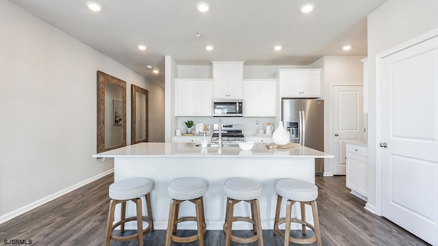 17 N 10th St, Middle Township, NJ 08251 - kitchen featuring appliances with stainless steel finishes, a breakfast bar, an island with sink, dark wood-type flooring, and recessed lighting