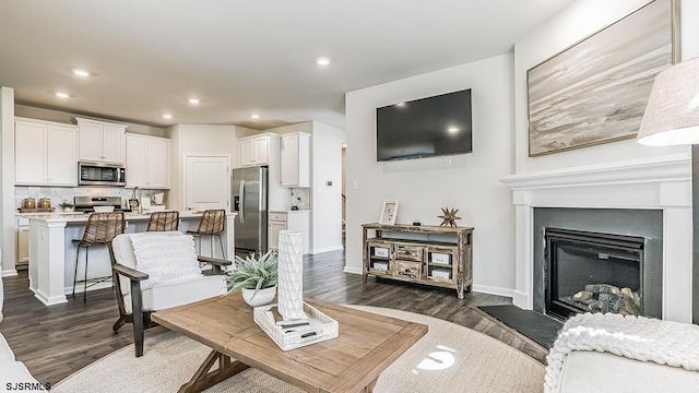 57 Siegtown Rd, Middle Township, NJ 08210 - living room featuring dark wood finished floors, recessed lighting, and a fireplace with raised hearth