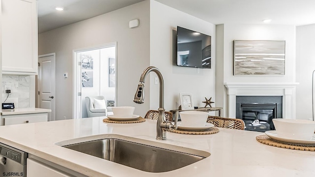 57 Siegtown Rd, Middle Township, NJ 08210 - detailed view of white cabinets, a glass covered fireplace, dishwasher, backsplash, and recessed lighting