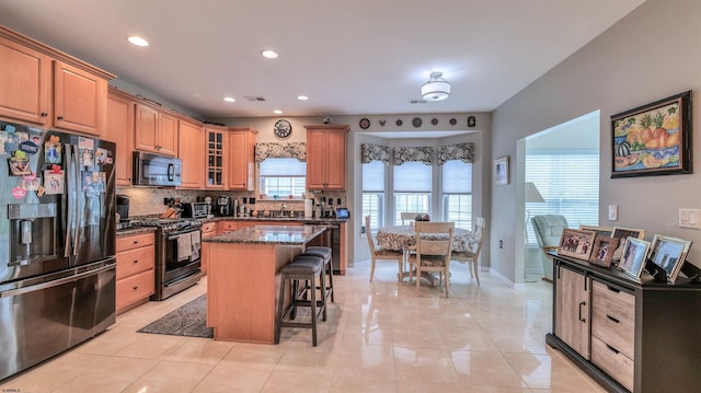 229 Lander Rd, Egg Harbor Township, NJ 08234 - kitchen featuring black appliances, decorative backsplash, a breakfast bar, dark stone counters, and recessed lighting