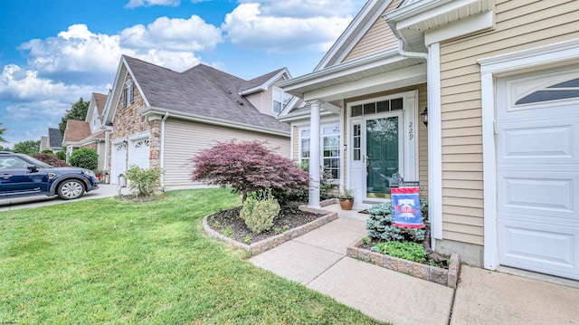 229 Lander Rd, Egg Harbor Township, NJ 08234 - doorway to property featuring a yard, a garage, stone siding, and driveway