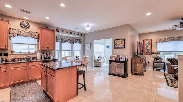 229 Lander Rd, Egg Harbor Township, NJ 08234 - kitchen with a kitchen bar, tasteful backsplash, recessed lighting, a kitchen island, and dark stone counters