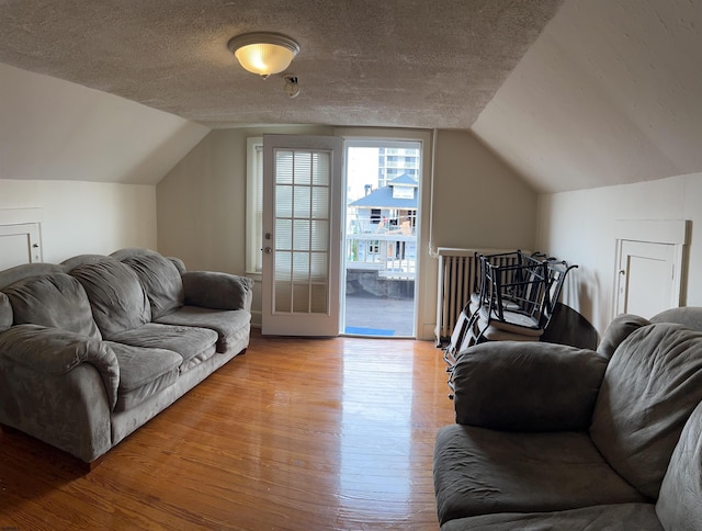 215 N Dorset, Ventnor Heights, NJ 08406 - living room featuring wood finished floors, vaulted ceiling, and a textured ceiling