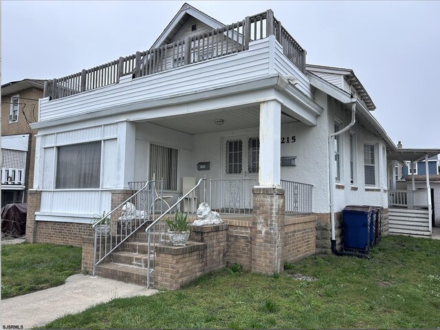 215 N Dorset, Ventnor Heights, NJ 08406 - view of front facade with a balcony, covered porch, and a front yard