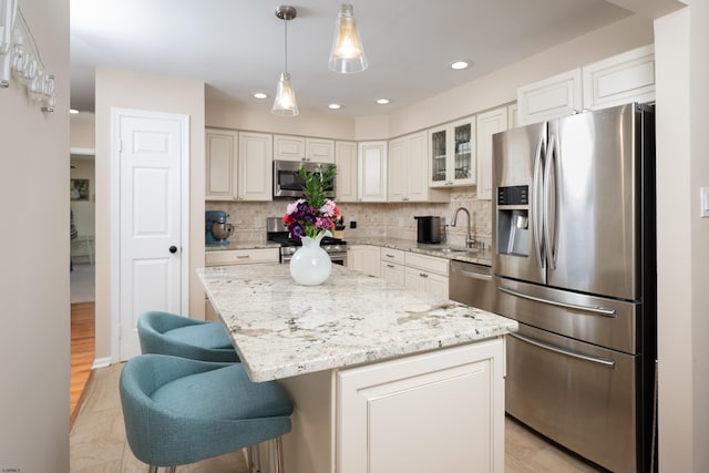 229 Society Hill Blvd Unit 229, Cherry Hill, NJ 08003 - kitchen with stainless steel appliances, backsplash, light stone countertops, a kitchen bar, and recessed lighting