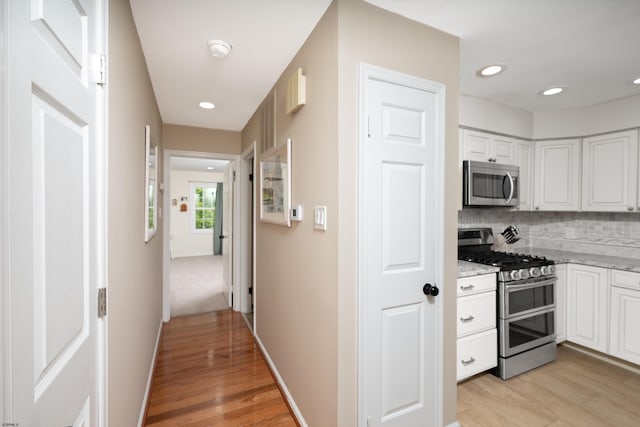 229 Society Hill Blvd Unit 229, Cherry Hill, NJ 08003 - kitchen with appliances with stainless steel finishes, white cabinets, tasteful backsplash, light wood finished floors, and recessed lighting