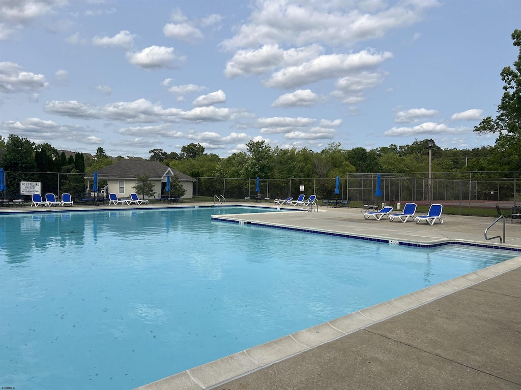 2603 Canyon Ct Unit 2603, Hamilton Township, NJ 08330 - community pool featuring a patio and view of wooded area