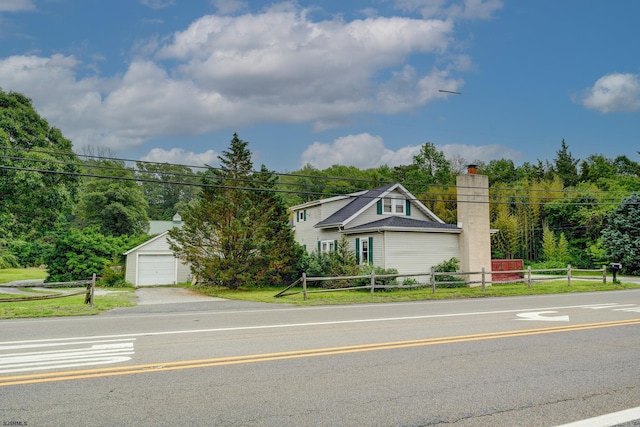 1081 Rte 50, Petersburg, NJ 08270 - view of front of house featuring a chimney, a garage, an outdoor structure, and driveway