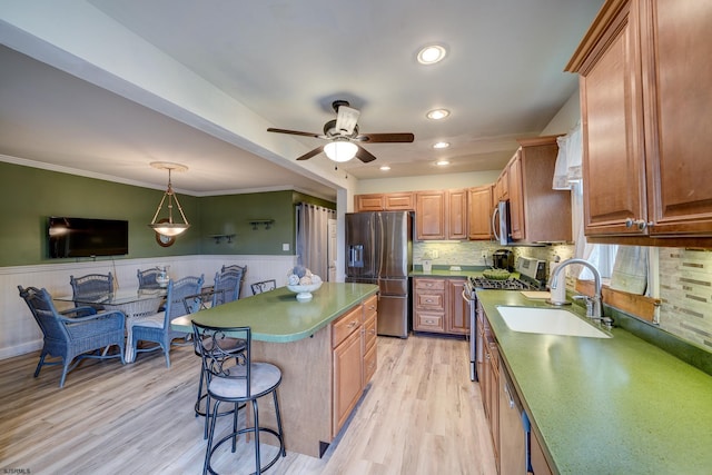 1081 Rte 50, Petersburg, NJ 08270 - kitchen featuring stainless steel appliances, a ceiling fan, a wainscoted wall, a kitchen breakfast bar, and light wood finished floors