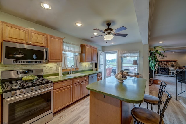 1081 Rte 50, Petersburg, NJ 08270 - kitchen featuring appliances with stainless steel finishes, a breakfast bar, light wood-style flooring, a ceiling fan, and recessed lighting
