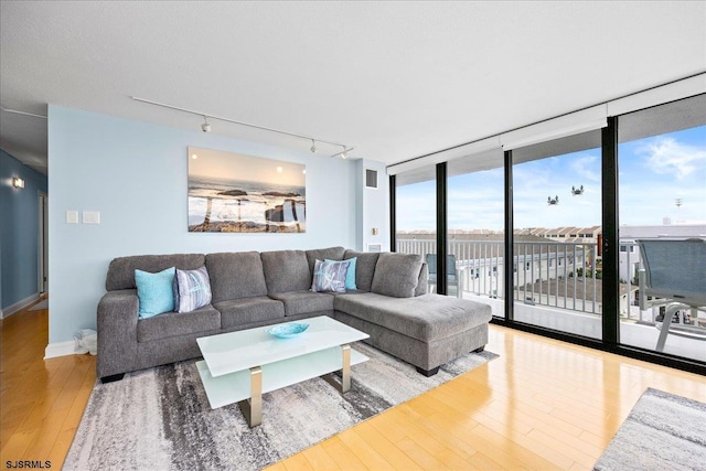 111 S 16th Ave Unit 415, Longport, NJ 08403 - living area with track lighting, hardwood / wood-style flooring, and expansive windows