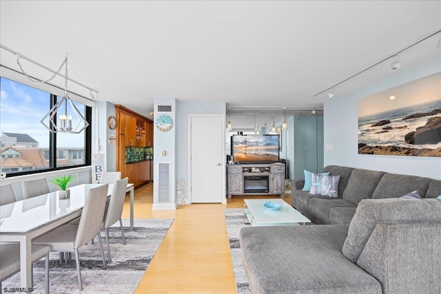 111 S 16th Ave Unit 415, Longport, NJ 08403 - living room with track lighting, light wood-style floors, and a chandelier