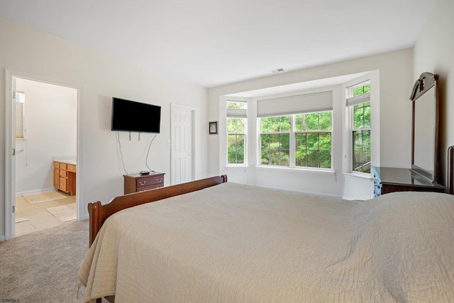 11 Brampton St, Galloway Township, NJ 08205 - bedroom featuring multiple windows, connected bathroom, and light tile patterned flooring