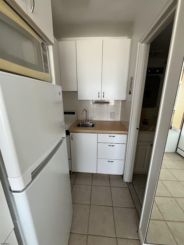 108 S Montpelier Ave Unit 206, Atlantic City, NJ 08401 - kitchen with white appliances, white cabinets, decorative backsplash, and light tile patterned flooring