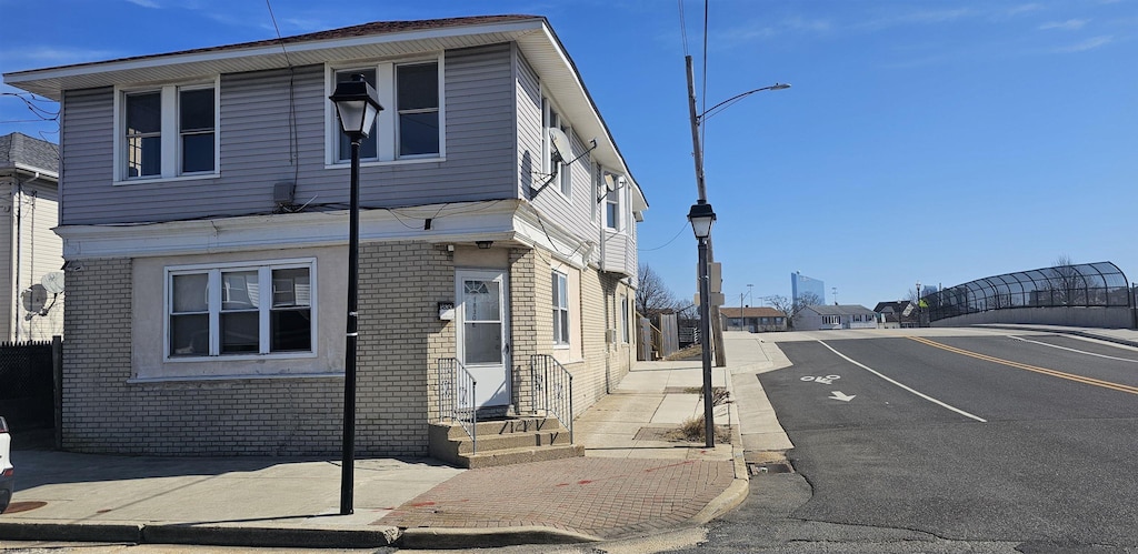 1830 E Riverside Dr, Atlantic City, NJ 08401 - view of front of home with brick siding, entry steps, and uncovered parking