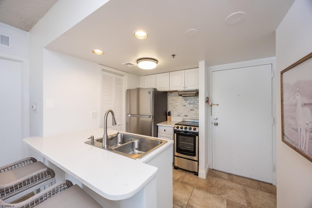 3851 Boardwalk Unit 1805, Atlantic City, NJ 08401 - kitchen featuring stainless steel appliances, backsplash, white cabinets, a kitchen bar, and a peninsula