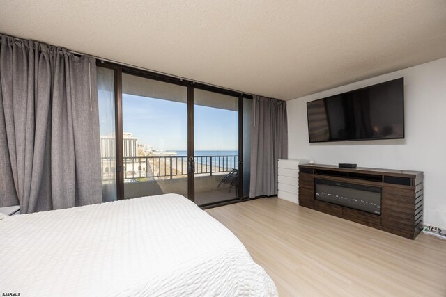 3851 Boardwalk Unit 1805, Atlantic City, NJ 08401 - bedroom with access to outside, wood finished floors, and a glass covered fireplace