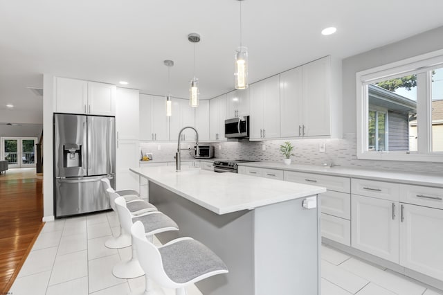 106 Hillside Ave, Absecon, NJ 08201 - kitchen featuring appliances with stainless steel finishes, plenty of natural light, decorative backsplash, recessed lighting, and a center island with sink