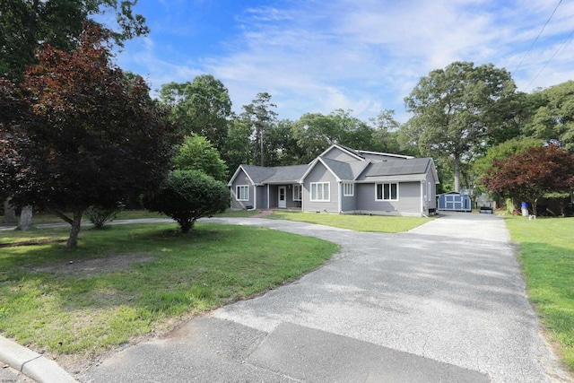 106 Hillside Ave, Absecon, NJ 08201 - ranch-style house featuring curved driveway, roof mounted solar panels, and a front yard