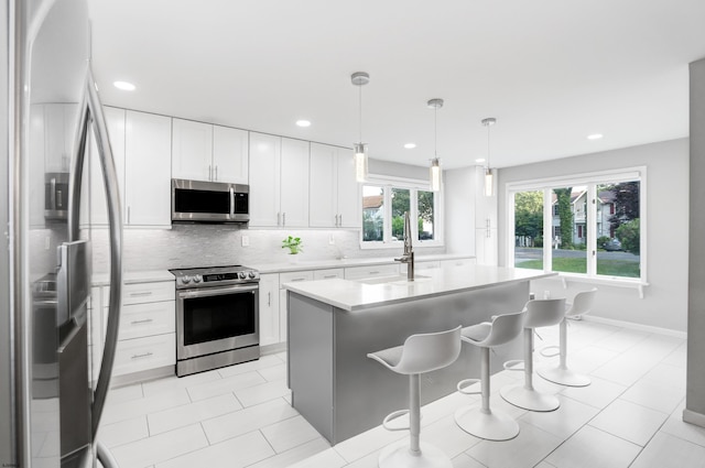 106 Hillside Ave, Absecon, NJ 08201 - kitchen with stainless steel appliances, light countertops, tasteful backsplash, recessed lighting, and a breakfast bar