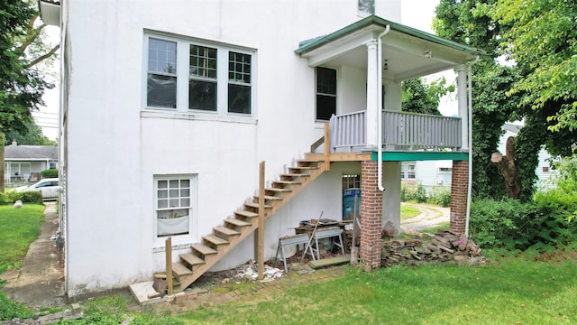 717 Wabash Ave, Atlantic City, NJ 08401 - rear view of property featuring stairway, stucco siding, covered porch, and a yard