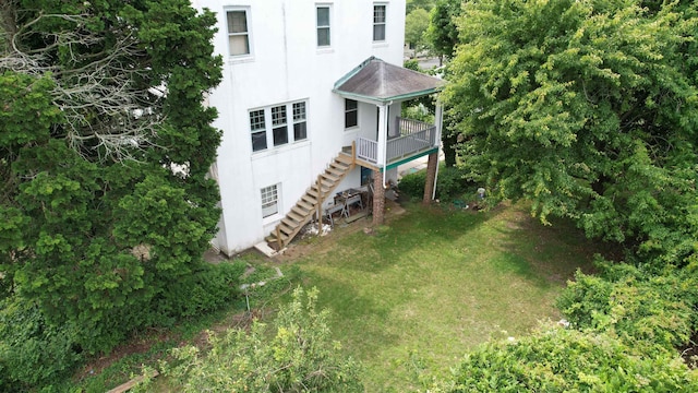 717 Wabash Ave, Atlantic City, NJ 08401 - view of side of home with stucco siding, stairs, a yard, and a deck