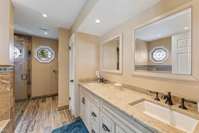 122 S Pointe Unit 122, Somers Point, NJ 08244 - bathroom with double vanity, a stall shower, recessed lighting, wood finish floors, and a closet