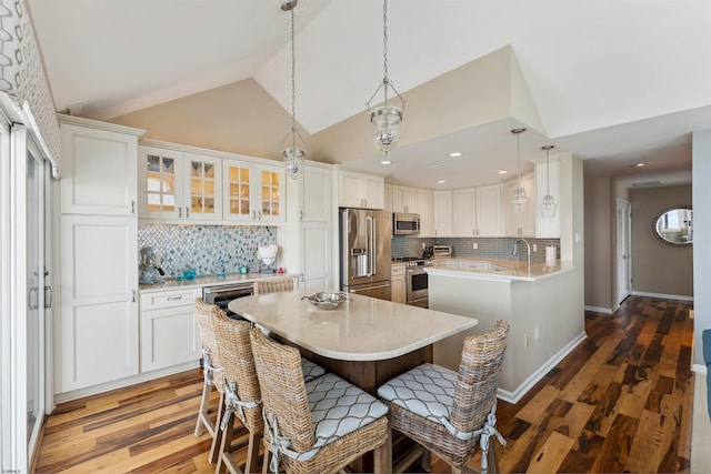 122 S Pointe Unit 122, Somers Point, NJ 08244 - kitchen with high end appliances, wood finished floors, decorative backsplash, light countertops, and white cabinetry
