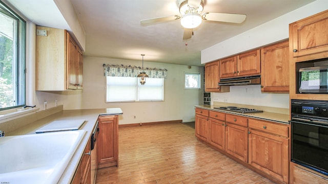 116 Post Rd, Mays Landing, NJ 08330 - kitchen with black appliances, under cabinet range hood, light wood-style flooring, brown cabinetry, and light countertops