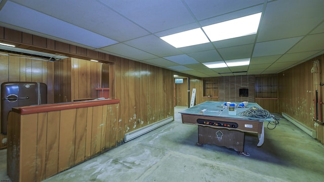 116 Post Rd, Mays Landing, NJ 08330 - game room featuring a baseboard radiator, wooden walls, concrete floors, a drop ceiling, and a brick fireplace