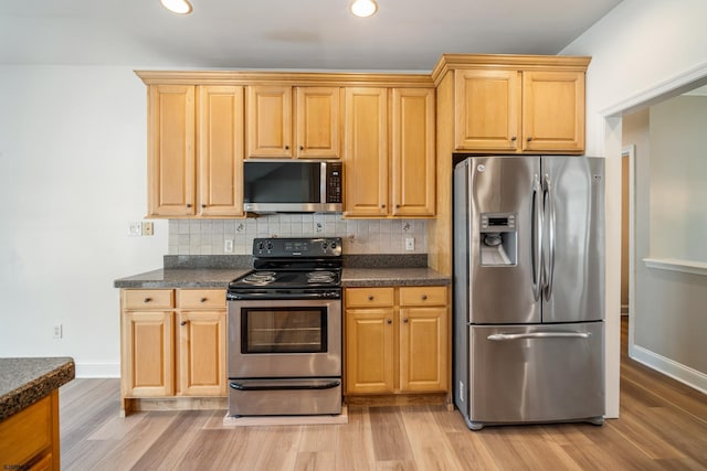 2 Clay Ct, Cape May, NJ 08204 - kitchen featuring appliances with stainless steel finishes, dark countertops, light wood-style flooring, backsplash, and recessed lighting