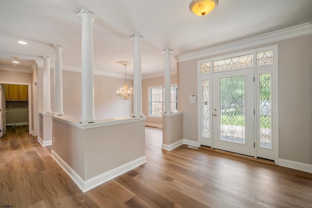 2 Clay Ct, Cape May, NJ 08204 - entryway featuring ornamental molding, wood finished floors, decorative columns, and a chandelier