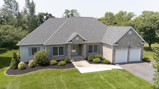 2 Clay Ct, Cape May, NJ 08204 - view of front facade featuring a front lawn, asphalt driveway, a garage, and brick siding