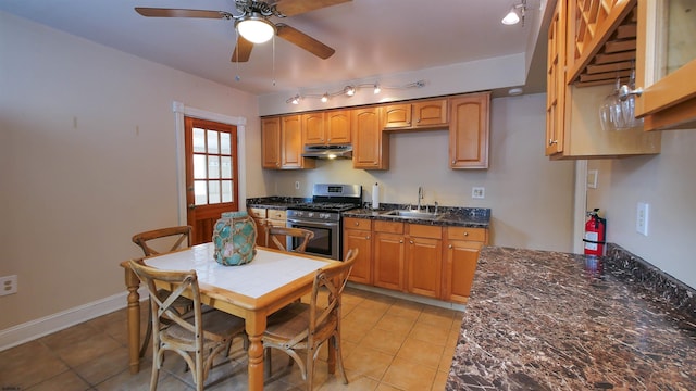 16 N Nashville Ave, Ventnor, NJ 08406 - kitchen featuring gas stove, under cabinet range hood, a ceiling fan, light tile patterned flooring, and brown cabinetry