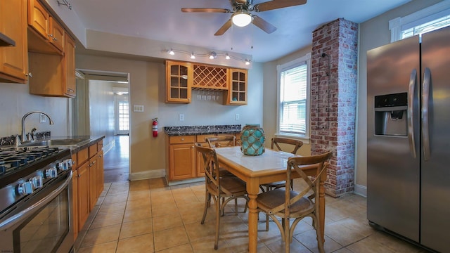 16 N Nashville Ave, Ventnor, NJ 08406 - kitchen featuring appliances with stainless steel finishes, healthy amount of natural light, glass insert cabinets, and light tile patterned floors