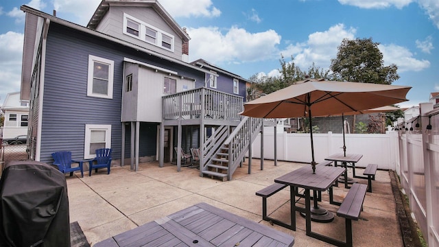 16 N Nashville Ave, Ventnor, NJ 08406 - back of property featuring a fenced backyard, a wooden deck, a patio area, stairway, and outdoor dining space