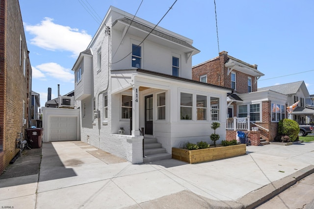 114 N Avolyn Ave, Ventnor, NJ 08406 - view of front of home featuring a garage, concrete driveway, and brick siding