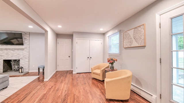 2308 Oak Ave, Northfield, NJ 08225 - living area with baseboard heating, wood finished floors, healthy amount of natural light, recessed lighting, and a stone fireplace