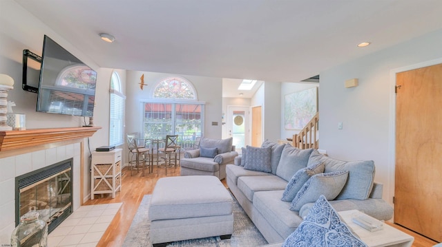 2 S Barclay Ave, Margate, NJ 08402 - living room featuring light wood-style floors, a tile fireplace, recessed lighting, and stairs