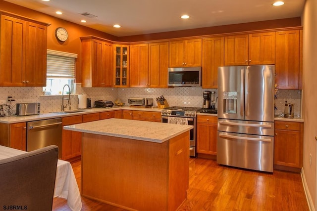 1 Poppy Rd, Egg Harbor Township, NJ 08234 - kitchen featuring stainless steel appliances, light wood finished floors, glass insert cabinets, backsplash, and recessed lighting