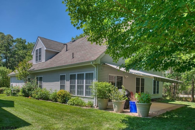 1 Poppy Rd, Egg Harbor Township, NJ 08234 - rear view of property featuring a lawn, a shingled roof, and a patio