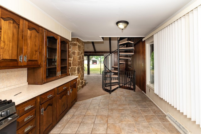 3821 Brookhaven Dr, Vineland, NJ 08361 - kitchen featuring light countertops, gas stove, glass insert cabinets, and stone finish floors