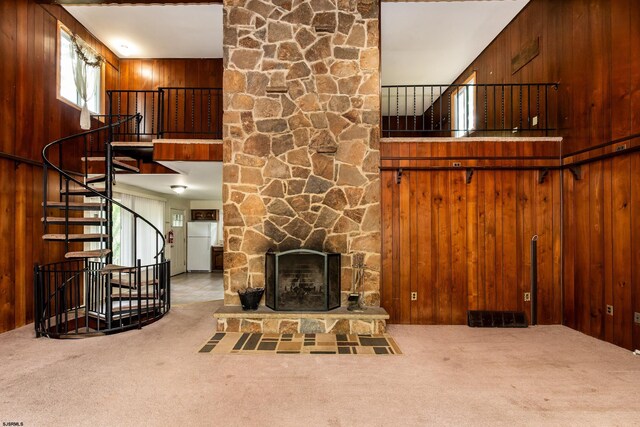 3821 Brookhaven Dr, Vineland, NJ 08361 - unfurnished living room featuring carpet flooring, wooden walls, stairway, a fireplace, and a towering ceiling