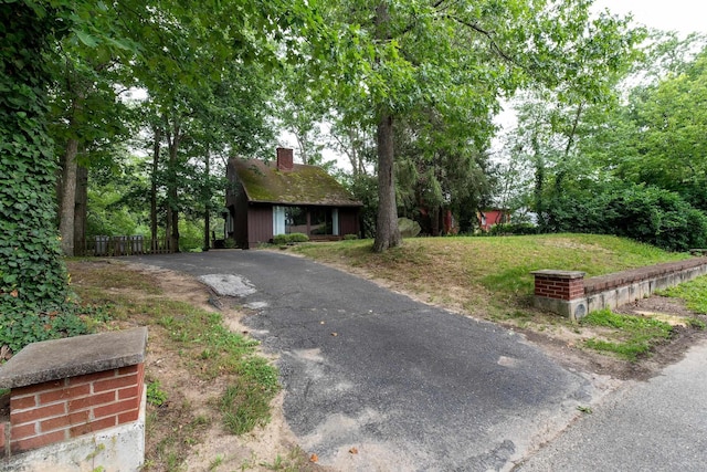 3821 Brookhaven Dr, Vineland, NJ 08361 - obstructed view of property featuring a chimney and asphalt driveway