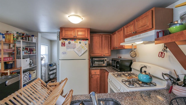 25 W 14th St Unit 1, Ocean City, NJ 08226 - kitchen featuring white appliances, under cabinet range hood, and brown cabinetry